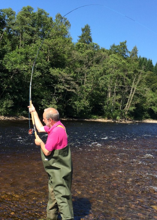 This pink shirted salmon angler is pictured here at the 'Joiner's Yard' Pool of the River Tummel near Ballinluig in Perthshire. He's learning the traditional Single Spey cast with this right hand. As he was doing so that day a salmon actually took the piece of red wool he was practising with!
